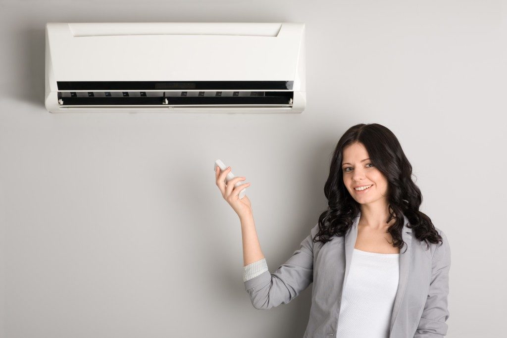 woman using air conditioner