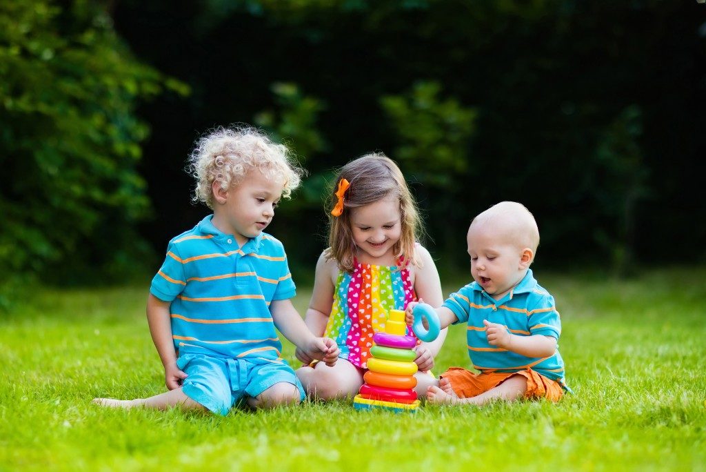 Kids playing with toys on the grass