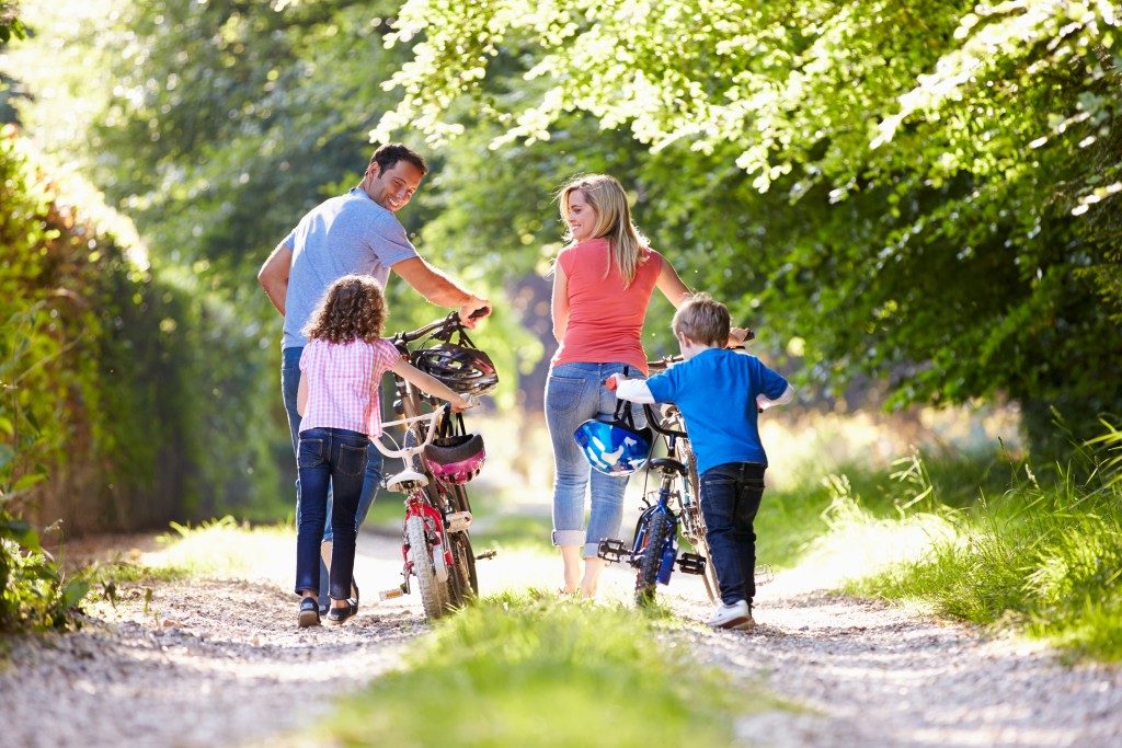 parents and their children going for a biking