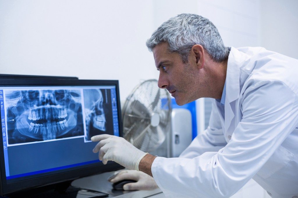 Dentist examining an x-ray