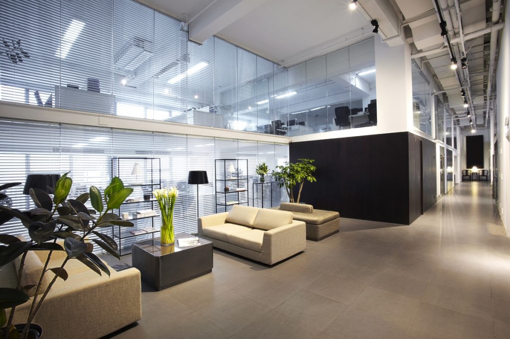 Modern office lobby with plants and couches