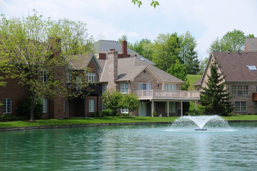 Brick Suburban Lake front Homes in the summer
