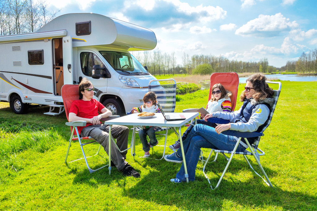 family relaxing together outdoors with their recreational vehicle