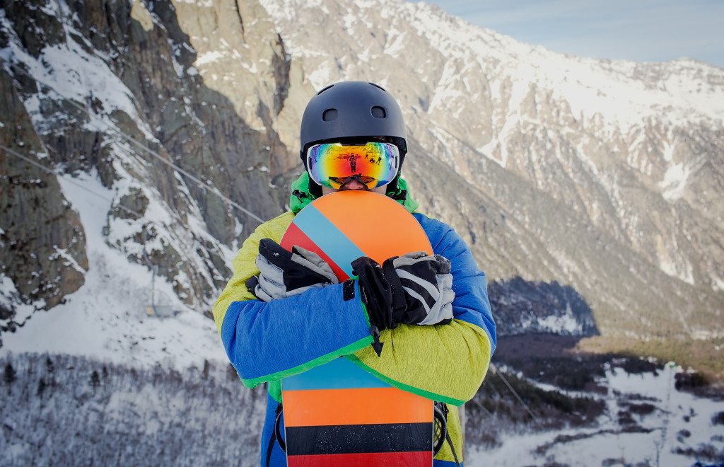 man holding a snowboard