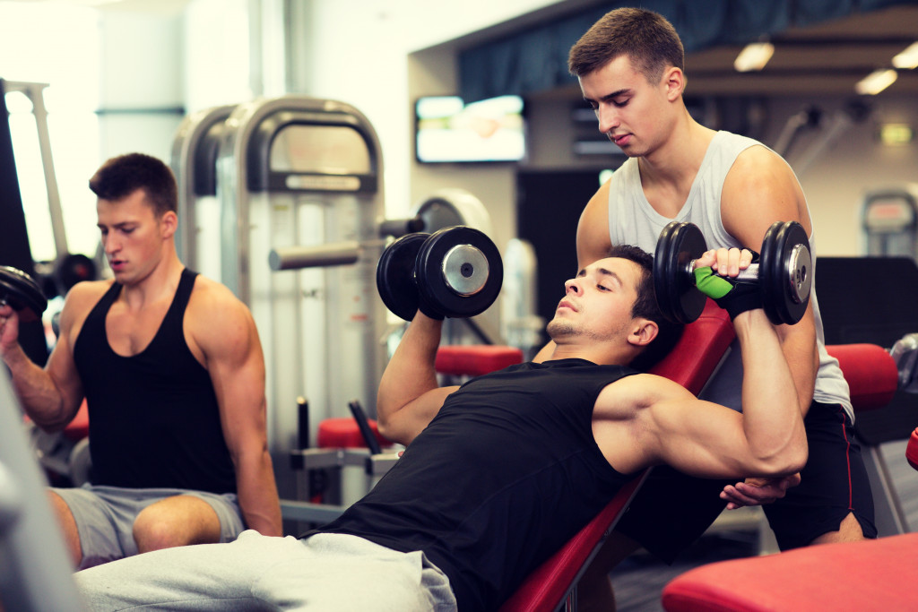 men exercising on a weight bench