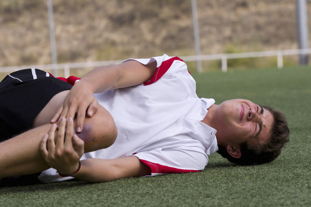 man in pain from an injury while playing a sport