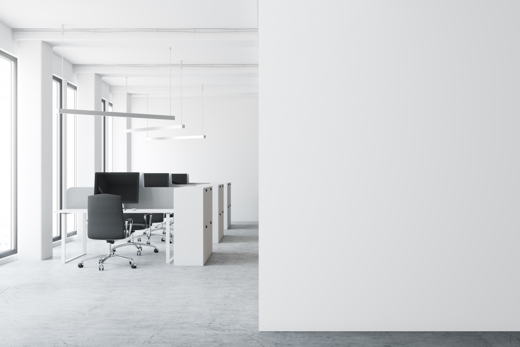 white and minimalist office space with work desk and chairs