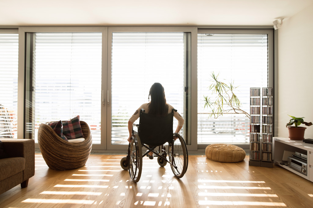 disabled woman at home looking out