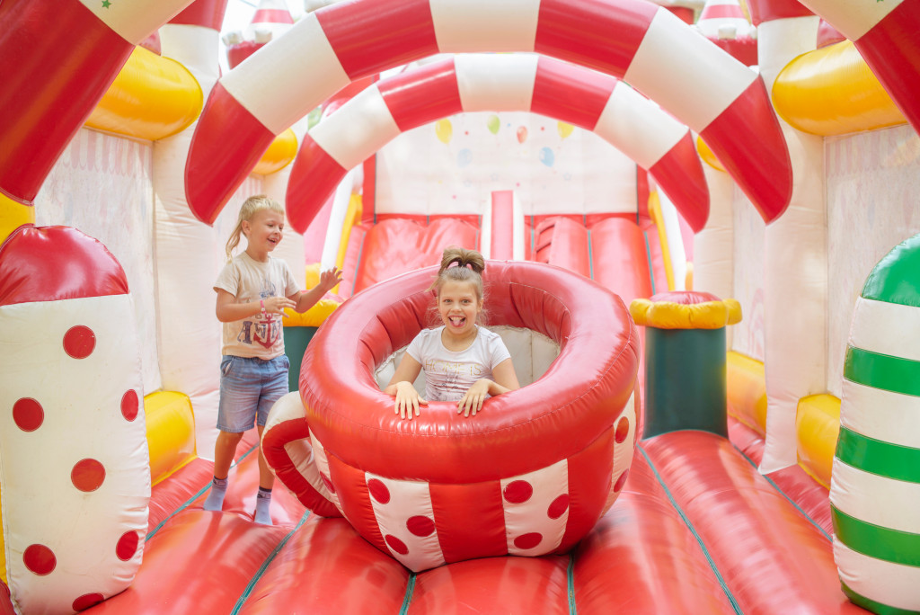 Two kids in an inflatable playground